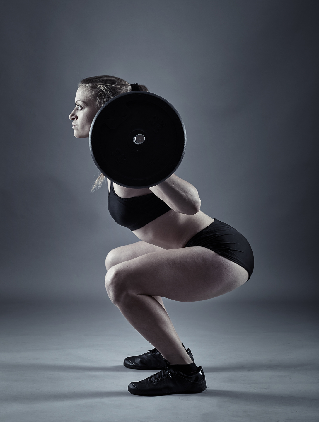 Young Woman Doing Barbell Squats